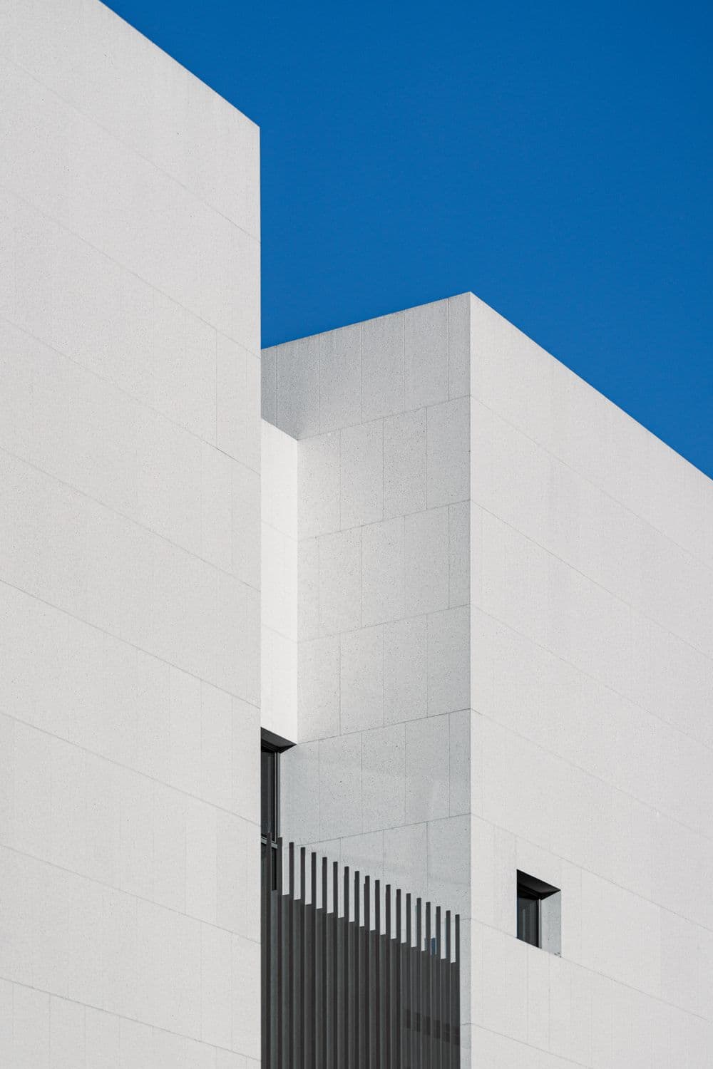 Detail of a modern building's geometric glass facade